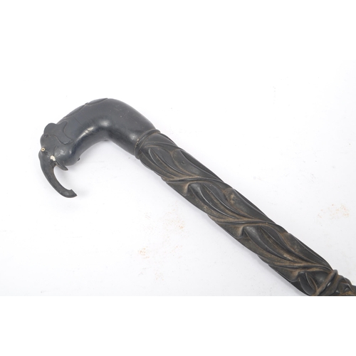 240 - An early 20th century Sri Lankan Ceylonese ebonised wooden carved elephant walking stick. The walkin... 