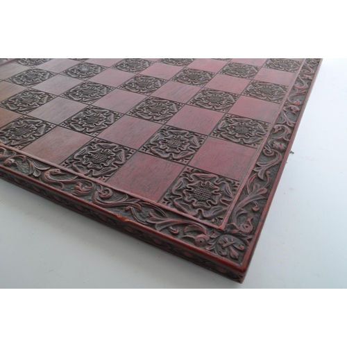 241 - A mid 20th century circa 1960s Chinese red lacquered wooden chess board. The chess board featuring a... 