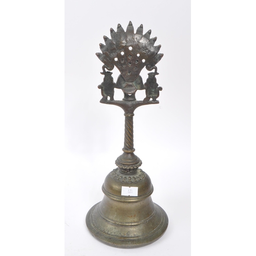 242 - An early 20th century North Indian brass Garuda Pooja prayer bell. The bell featuring a rounded bell... 