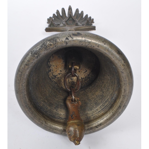 242 - An early 20th century North Indian brass Garuda Pooja prayer bell. The bell featuring a rounded bell... 