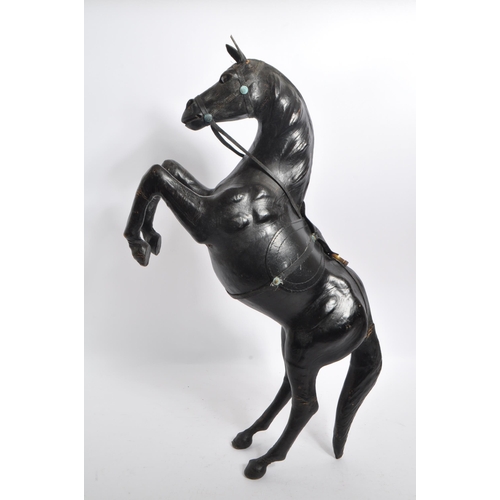 244 - Manner of Liberty - An early 20th century manner of Liberty leather rearing horse decoration figure.... 