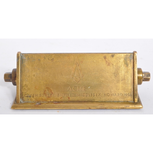 247 - A mid 20th century brass perpetual calendar. The calendar of elongated triangular form, featuring da... 