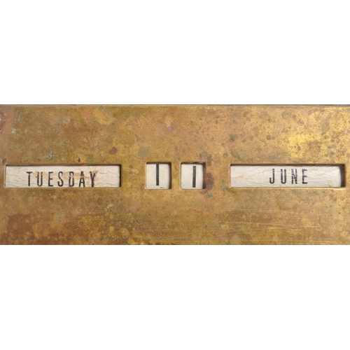 247 - A mid 20th century brass perpetual calendar. The calendar of elongated triangular form, featuring da... 