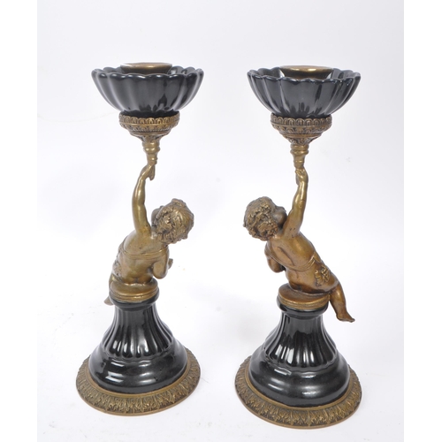 250 - A pair of early 20th century French Putto / Putti brass and ceramic candlesticks. The candlesticks f... 