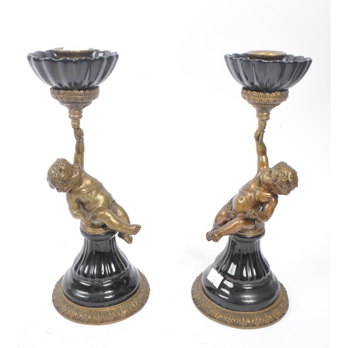 250 - A pair of early 20th century French Putto / Putti brass and ceramic candlesticks. The candlesticks f... 