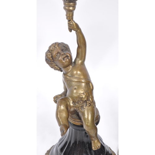 250 - A pair of early 20th century French Putto / Putti brass and ceramic candlesticks. The candlesticks f... 