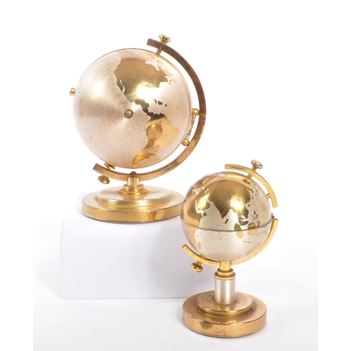 254 - A 20th century desktop gilt metal globe clock and table lighter. Each piece raised on a round steppe... 