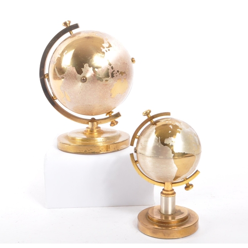 254 - A 20th century desktop gilt metal globe clock and table lighter. Each piece raised on a round steppe... 