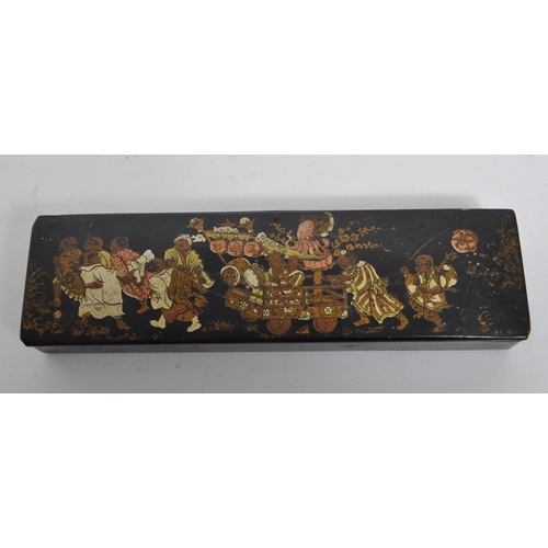 258 - An early 20th century circa. 1920s Japanese lacquered pen box. The pen box having black lacquered fi... 