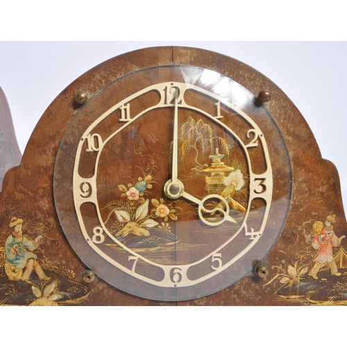 262 - Two early 20th century British ' Japanned ' mantel clocks. The larger of the two clocks having a tam... 