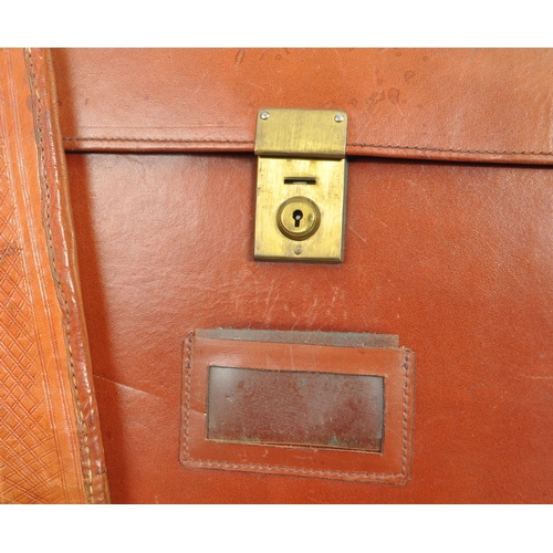 264 - A collection of vintage leather document / folio cases carriers to include tooled example with brass... 