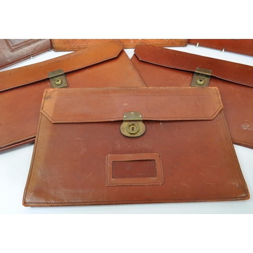 264 - A collection of vintage leather document / folio cases carriers to include tooled example with brass... 