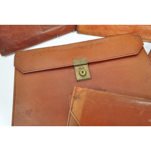 264 - A collection of vintage leather document / folio cases carriers to include tooled example with brass... 