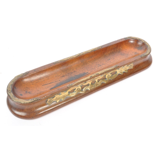 267 - Early 20th century brass mounted pen tray. Of walnut construction with dipped centre and brass decor... 