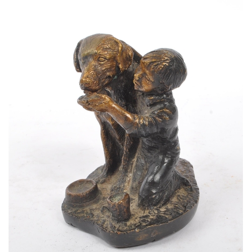 269 - Schultz - A bronze figure in the form of a boy feeding dog upon base signed ' Schultz '. The dog in ... 