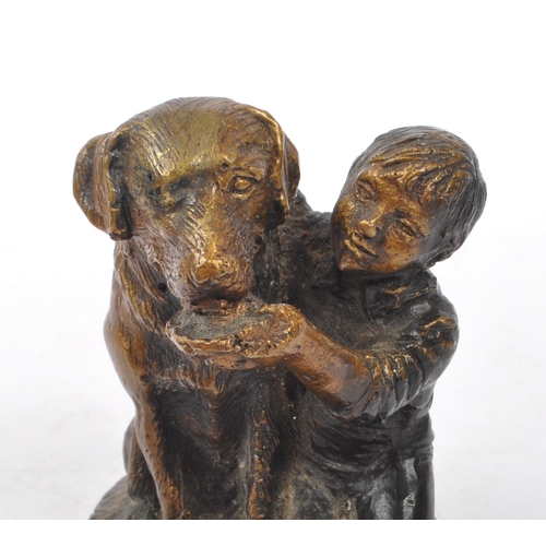 269 - Schultz - A bronze figure in the form of a boy feeding dog upon base signed ' Schultz '. The dog in ... 