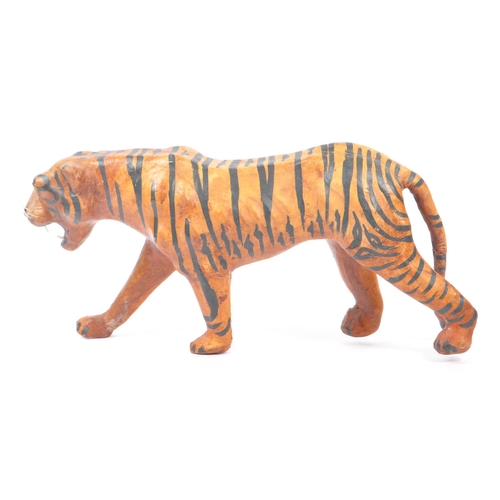 273 - A 20th Century circa. 1960s painted faux leather papier mache French tiger figure. The figure being ... 