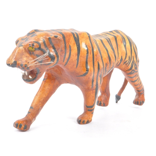 273 - A 20th Century circa. 1960s painted faux leather papier mache French tiger figure. The figure being ... 