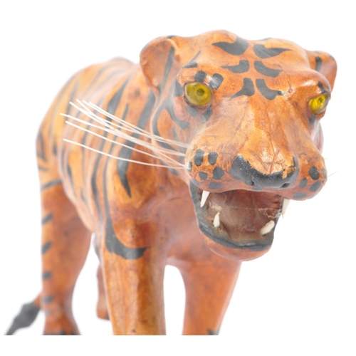 273 - A 20th Century circa. 1960s painted faux leather papier mache French tiger figure. The figure being ... 