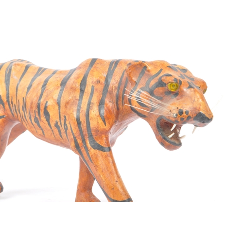 273 - A 20th Century circa. 1960s painted faux leather papier mache French tiger figure. The figure being ... 