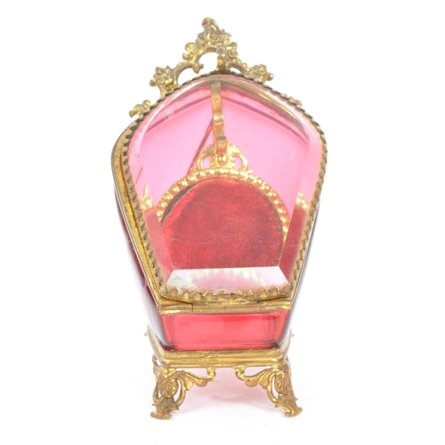 274 - A 19th Century Victorian cranberry glass and gilt metal pocket watch holder / display case upon four... 