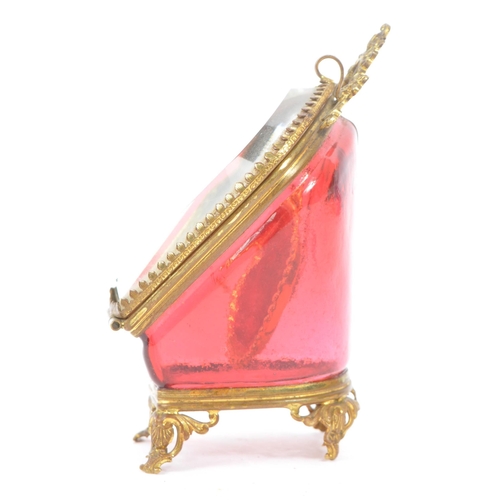 274 - A 19th Century Victorian cranberry glass and gilt metal pocket watch holder / display case upon four... 