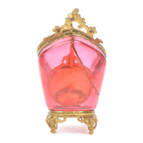 274 - A 19th Century Victorian cranberry glass and gilt metal pocket watch holder / display case upon four... 