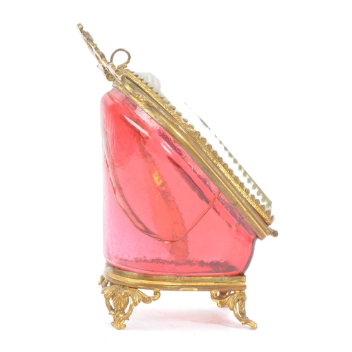 274 - A 19th Century Victorian cranberry glass and gilt metal pocket watch holder / display case upon four... 