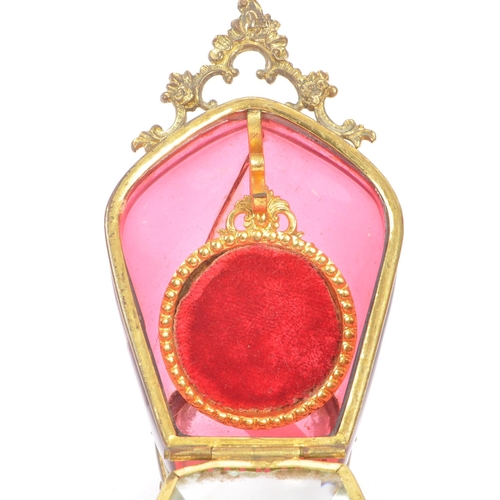 274 - A 19th Century Victorian cranberry glass and gilt metal pocket watch holder / display case upon four... 