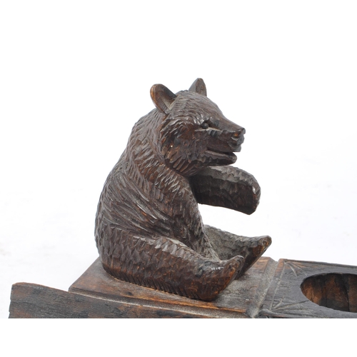 275 - An early 20th Century Chinese black forest manner carved bear inkwell having pen holder and and pen ... 