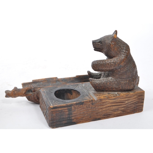 275 - An early 20th Century Chinese black forest manner carved bear inkwell having pen holder and and pen ... 