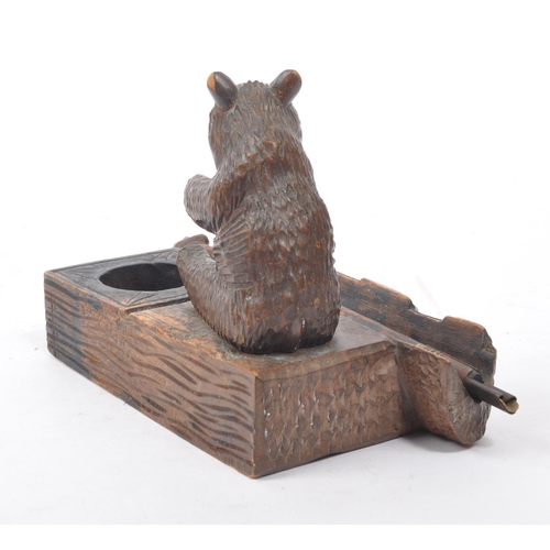 275 - An early 20th Century Chinese black forest manner carved bear inkwell having pen holder and and pen ... 