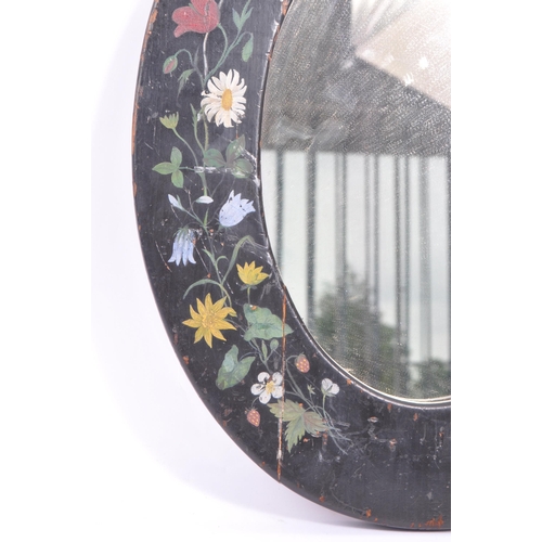 278 - An early 20th Century toleware hand painted folk art style wooden oval mirror having painted black g... 