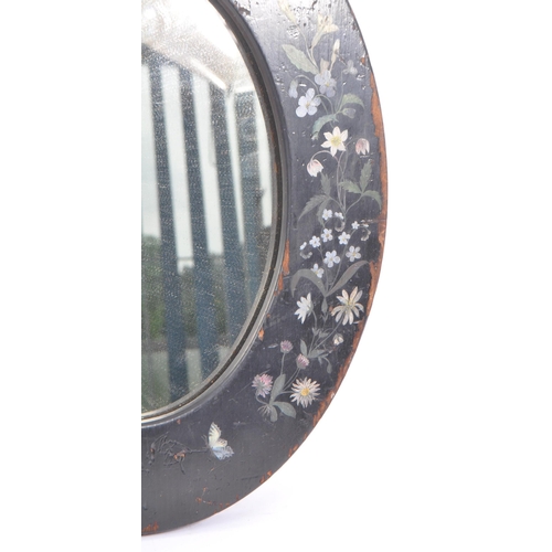 278 - An early 20th Century toleware hand painted folk art style wooden oval mirror having painted black g... 