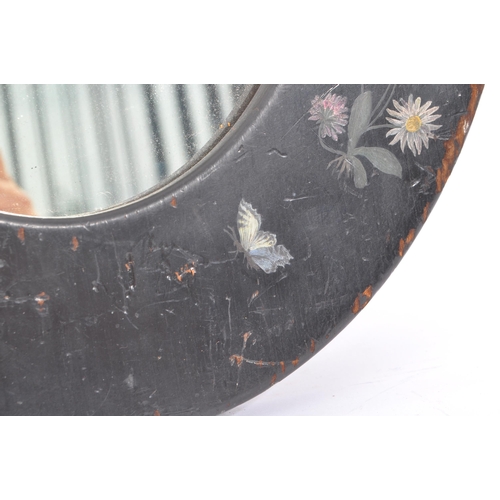 278 - An early 20th Century toleware hand painted folk art style wooden oval mirror having painted black g... 