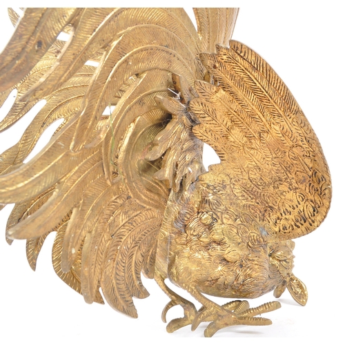 286 - A large brass figure in the form of a fighting cockerel in poised position forwards with wings sprea... 