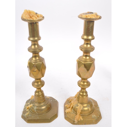 291 - Two pairs of19th Century Victorian brass candlesticks to include a pair of ' Queen of Diamonds ' bot... 