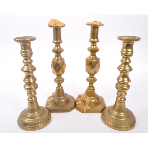 291 - Two pairs of19th Century Victorian brass candlesticks to include a pair of ' Queen of Diamonds ' bot... 