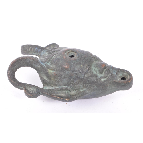 292 - A bronze Roman style oil lamp in the form of a faun / devil face with pointed ears and large curved ... 