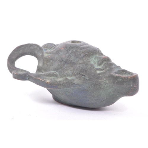 292 - A bronze Roman style oil lamp in the form of a faun / devil face with pointed ears and large curved ... 