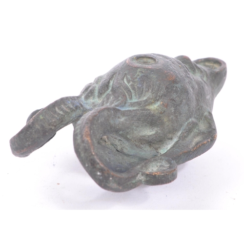 292 - A bronze Roman style oil lamp in the form of a faun / devil face with pointed ears and large curved ... 