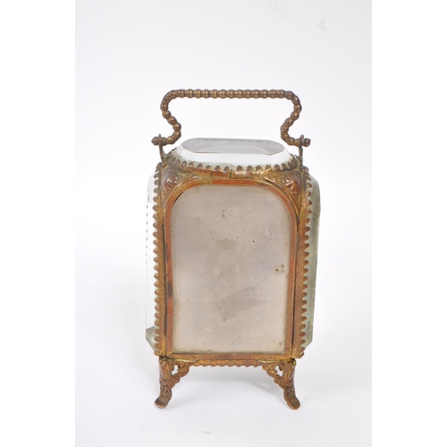 296 - An early 20th Century French glass and gilt metal miniature jewellery / pocket watch holder / vitrin... 