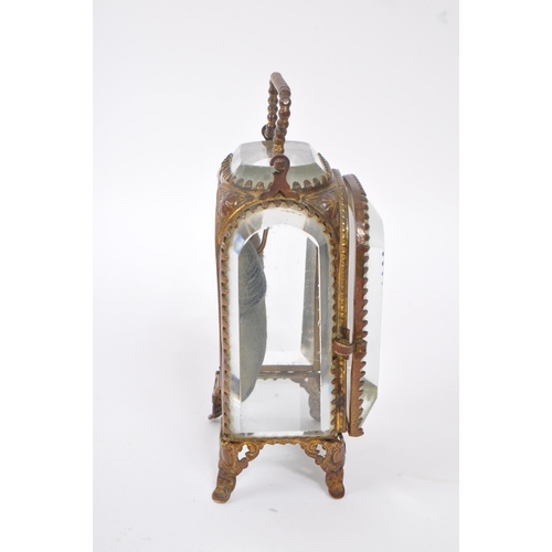 296 - An early 20th Century French glass and gilt metal miniature jewellery / pocket watch holder / vitrin... 