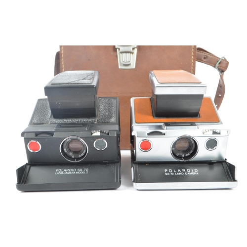 299 - Polaroid - Two 20th century circa 1970s Polaroid SX-70 SLR instant land cameras. Each camera having ... 