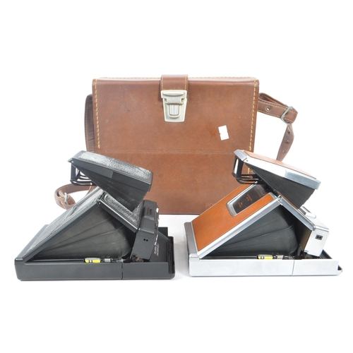 299 - Polaroid - Two 20th century circa 1970s Polaroid SX-70 SLR instant land cameras. Each camera having ... 