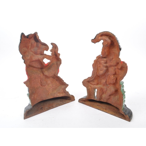 306 - Punch & Judy - A set of cast iron Punch and Judy doorstops. The figurative doorstops depicting Punch... 