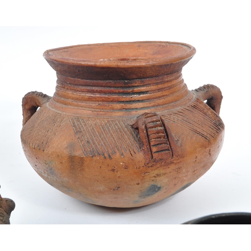 31 - A collection of clay East African Kenyan pottery pots. Some examples with textured bodies with raise... 