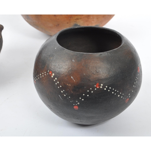 31 - A collection of clay East African Kenyan pottery pots. Some examples with textured bodies with raise... 