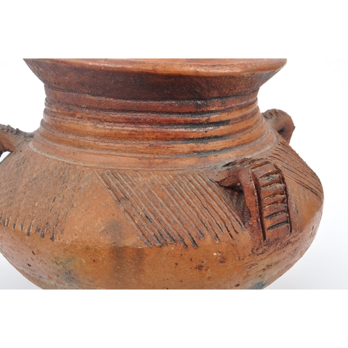 31 - A collection of clay East African Kenyan pottery pots. Some examples with textured bodies with raise... 