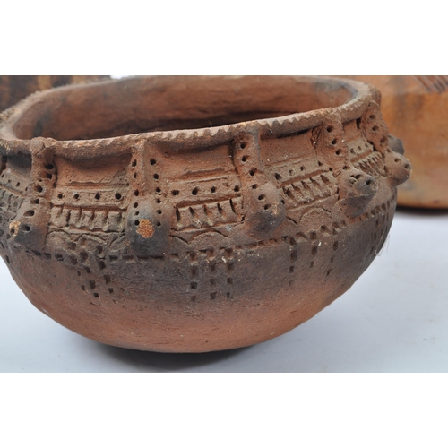 31 - A collection of clay East African Kenyan pottery pots. Some examples with textured bodies with raise... 